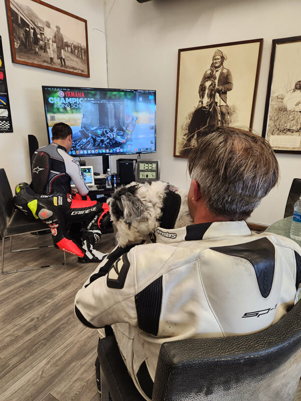 Marc watching a video of himself on the track while Chris gives suggestions.